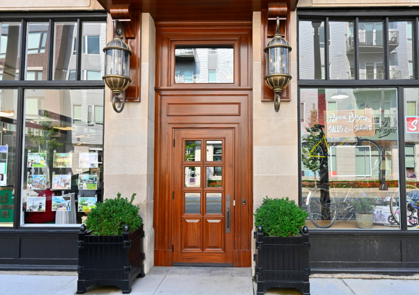 Custom wood entry door with divided glass lites and transom, crafted by Rockwood Door & Millwork for a historic commercial building in Cleveland, Ohio.
