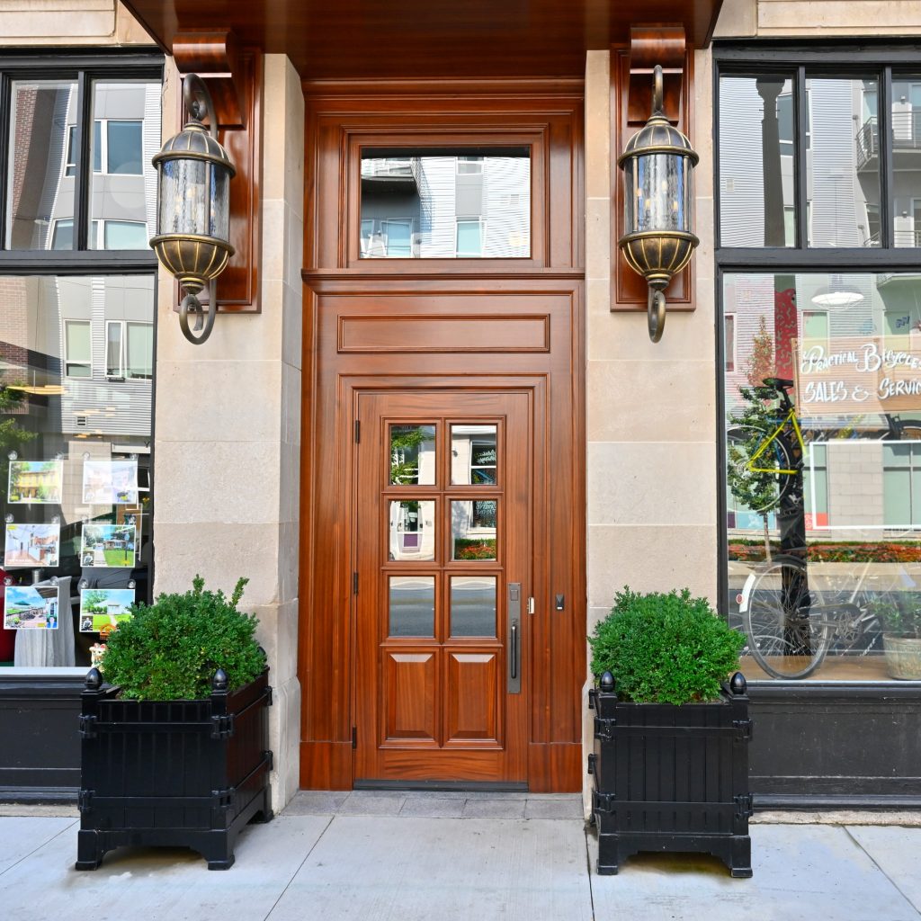 High-end commercial entryway featuring a custom mahogany door with transom and sidelights, part of a Rockwood Door & Millwork project in Cleveland, Ohio.