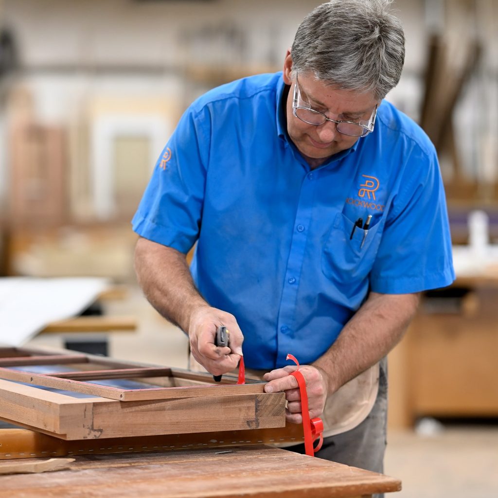 Skilled woodworker at Rockwood Door & Millwork in Millersburg, Ohio, showcasing hands-on craftsmanship in a rewarding, detail-focused career.