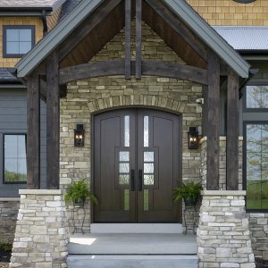 Custom contemporary double entry doors with glass inserts and arched top, designed by Rockwood Door & Millwork for a luxury stone-front home in Ohio.