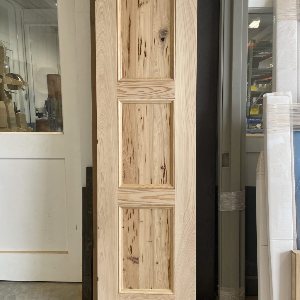 Custom interior door crafted from pecky cypress, showcasing natural character and handcrafted in Millersburg, Ohio by Rockwood Door & Millwork.