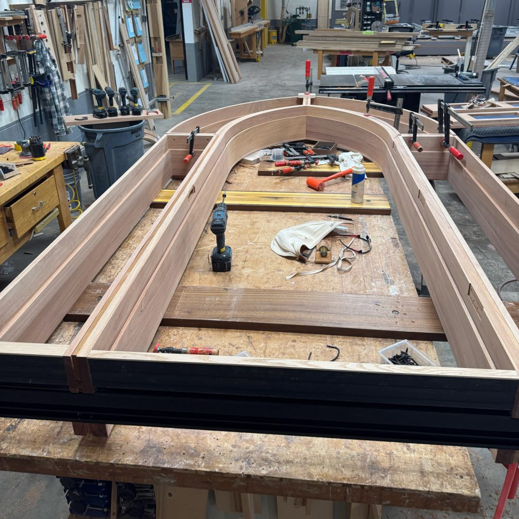 Gothic-style arched door frame under construction at Rockwood Door & Millwork’s workshop in Millersburg, Ohio, showcasing handcrafted historical reproduction techniques.