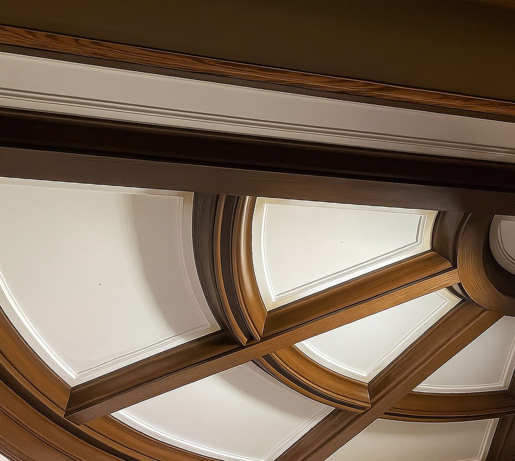 Finished curved ceiling millwork in Red Oak at the Athletic Club of Columbus, featuring custom moulding and radius-cut beams fabricated by Rockwood.