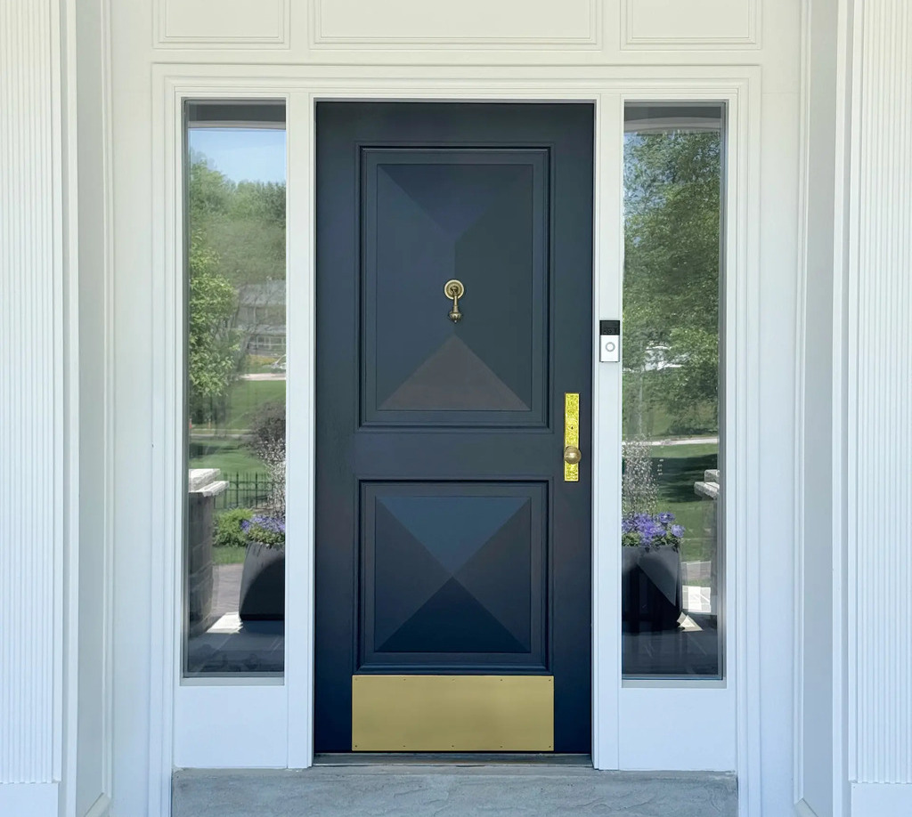 Custom painted Sipo wood entry door with pyramid panels and brass hardware crafted by Rockwood Door & Millwork in collaboration with Blue Ladder Studio.
