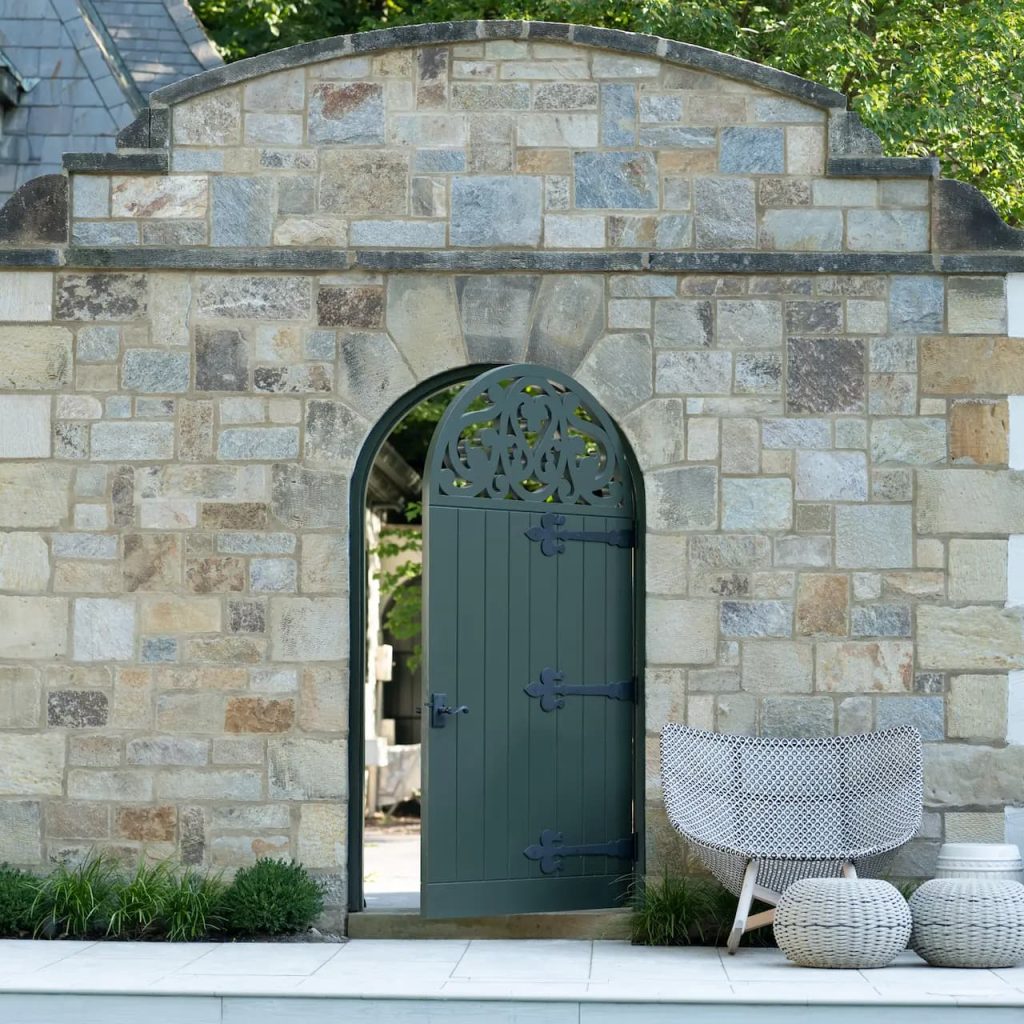 Rockwood used an original gate as the pattern, replicated the half-round top and scrollwork, and rebuilt the gates in mahogany with exterior-grade construction and practical, maintainable finishing.